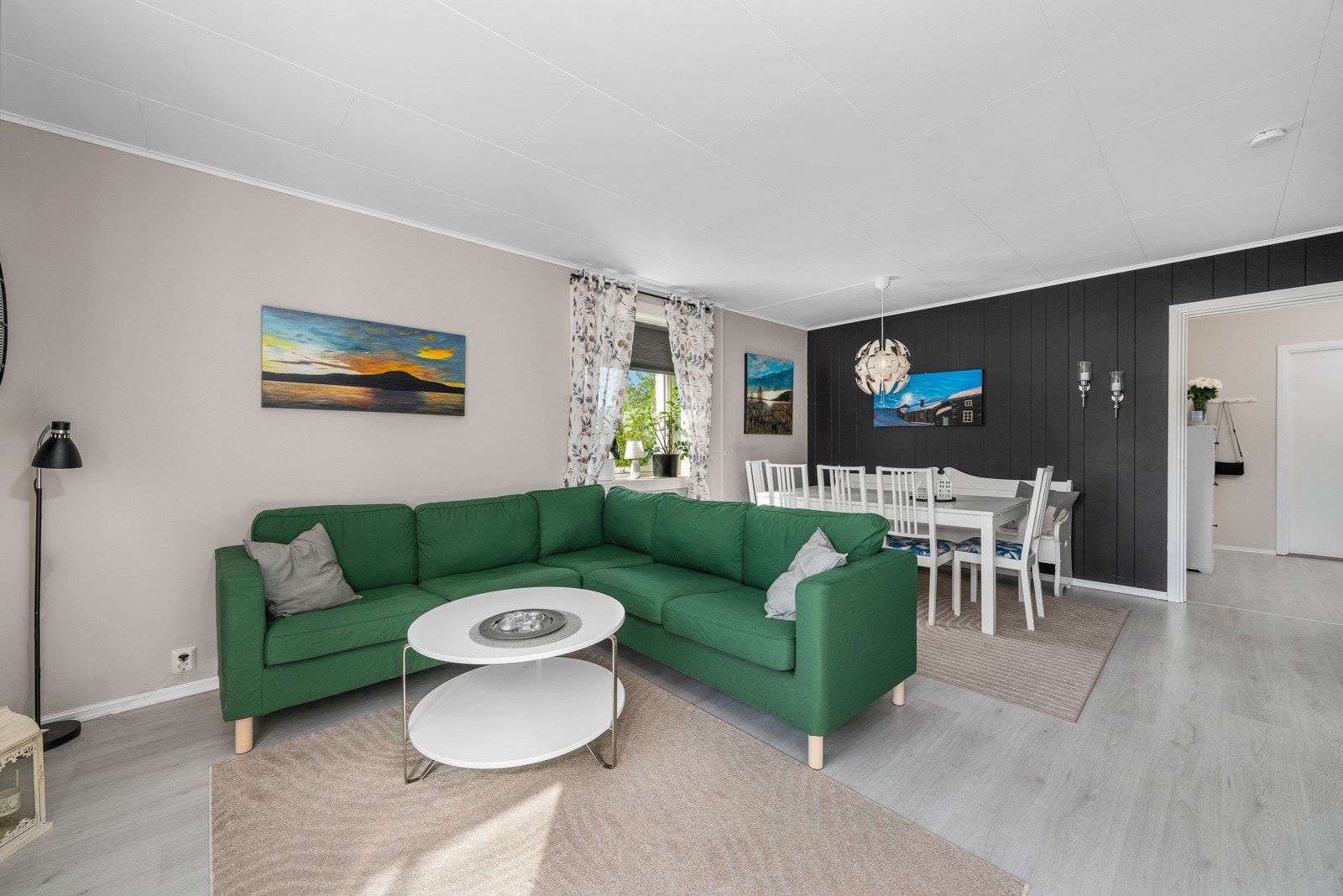 Boligens hjerterom er en lys og romslig stue med vinduer på to sider. Galleribilde