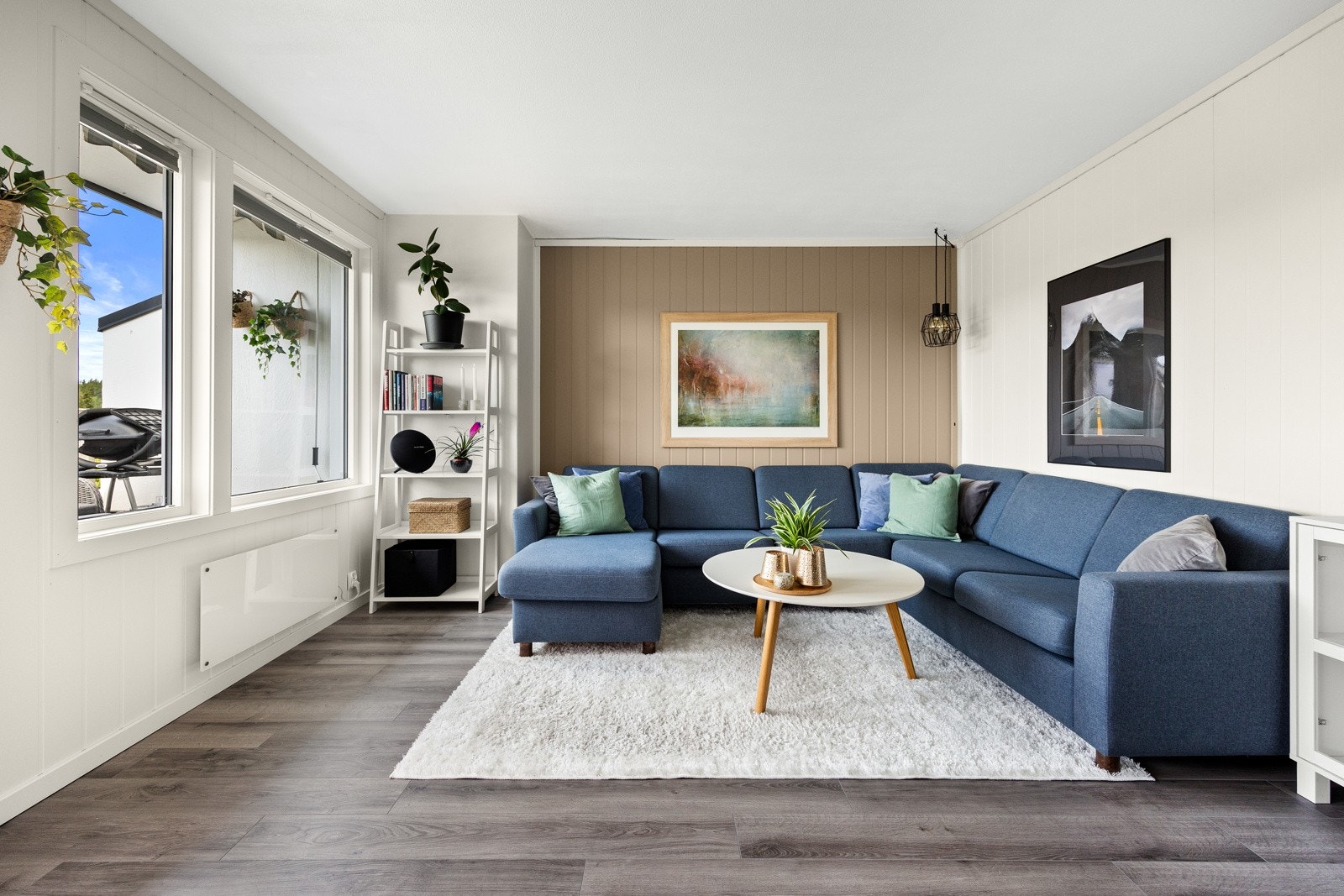 Stuen er et lyst og fint rom med balkongdør og et tofags vindu som fyller rommet med naturlig lys. Galleribilde