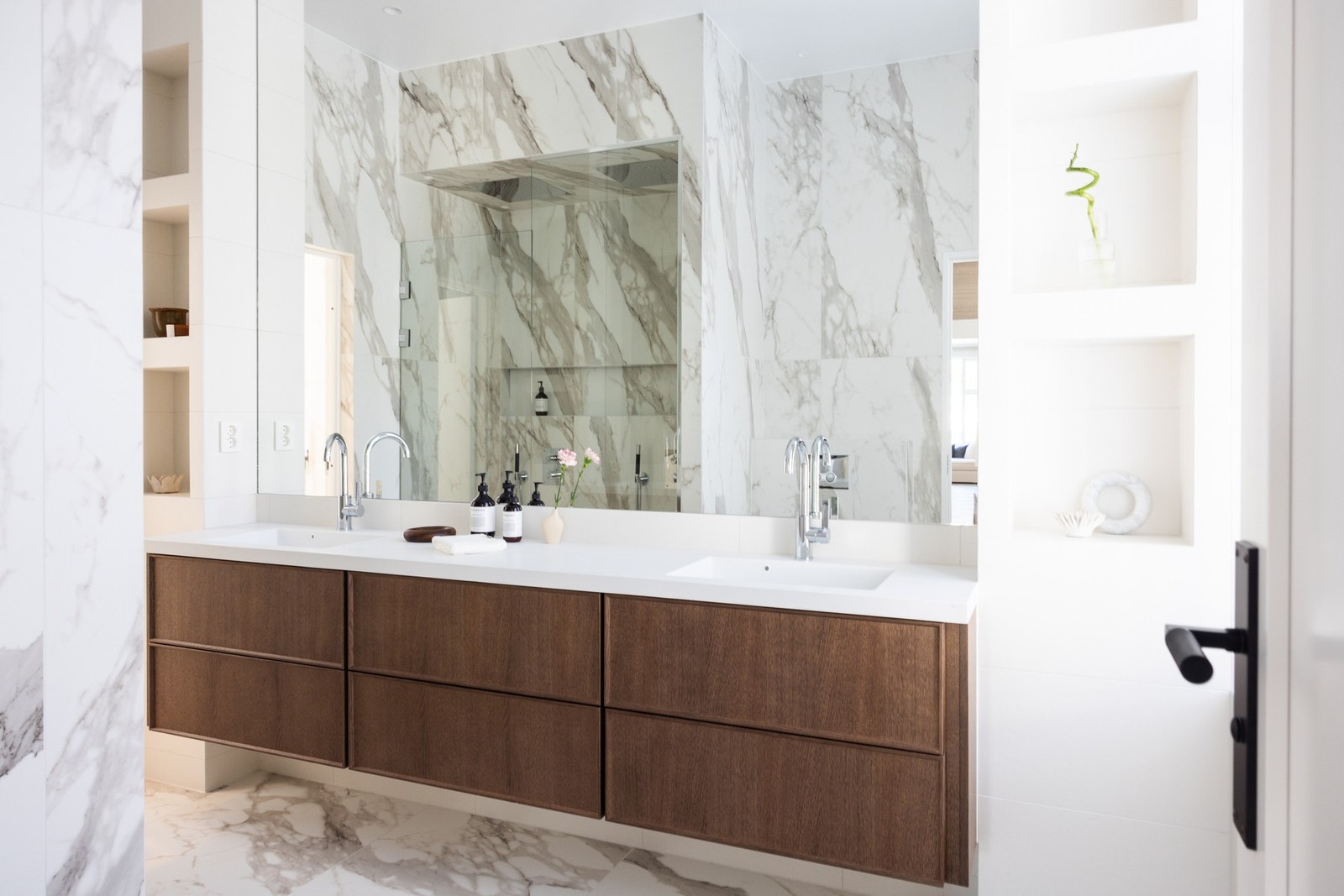 Bad med adkomst fra hovedsoverom er innredet med vakre marmorerte gulv- og veggfliser som gir et tidløst og elegant preg på rommet. Galleribilde