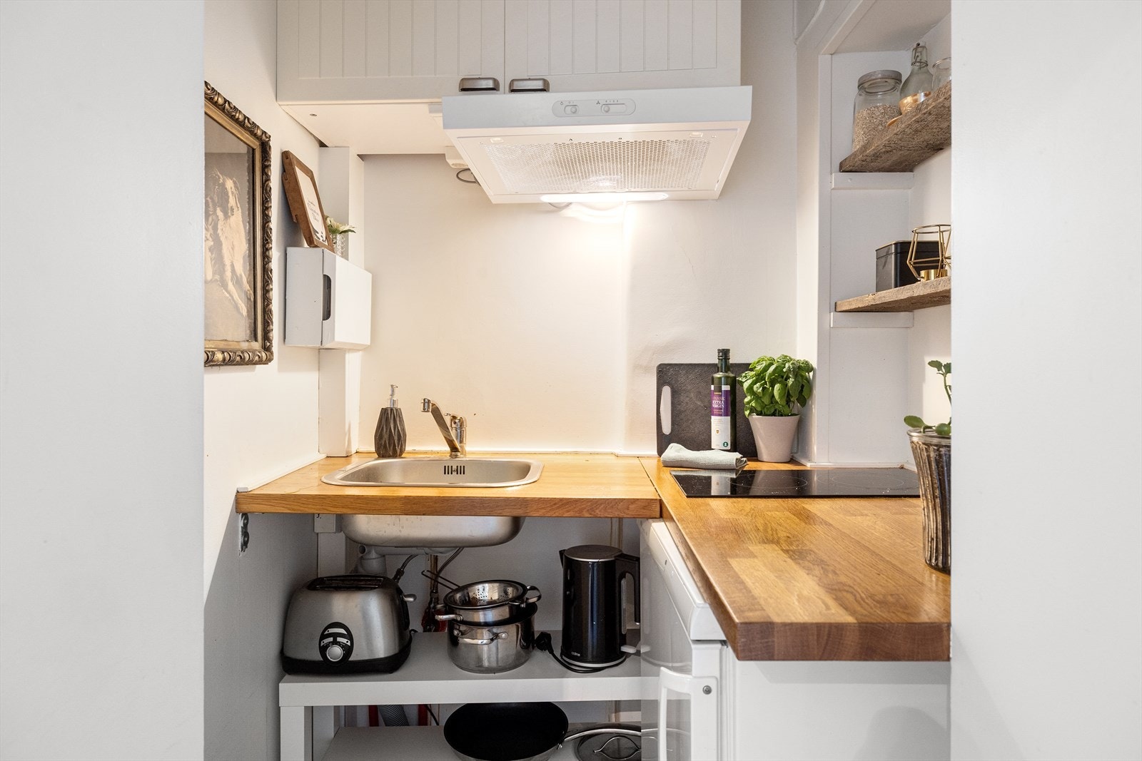 Enkelt kjøkken med benkeplate i eik. Etablering av kjøkkenkrok er ikke dokumentert omsøkt og/eller godkjent. Se punkt: ferdigattest / brukstillatelse i salgsoppgaven. Galleribilde