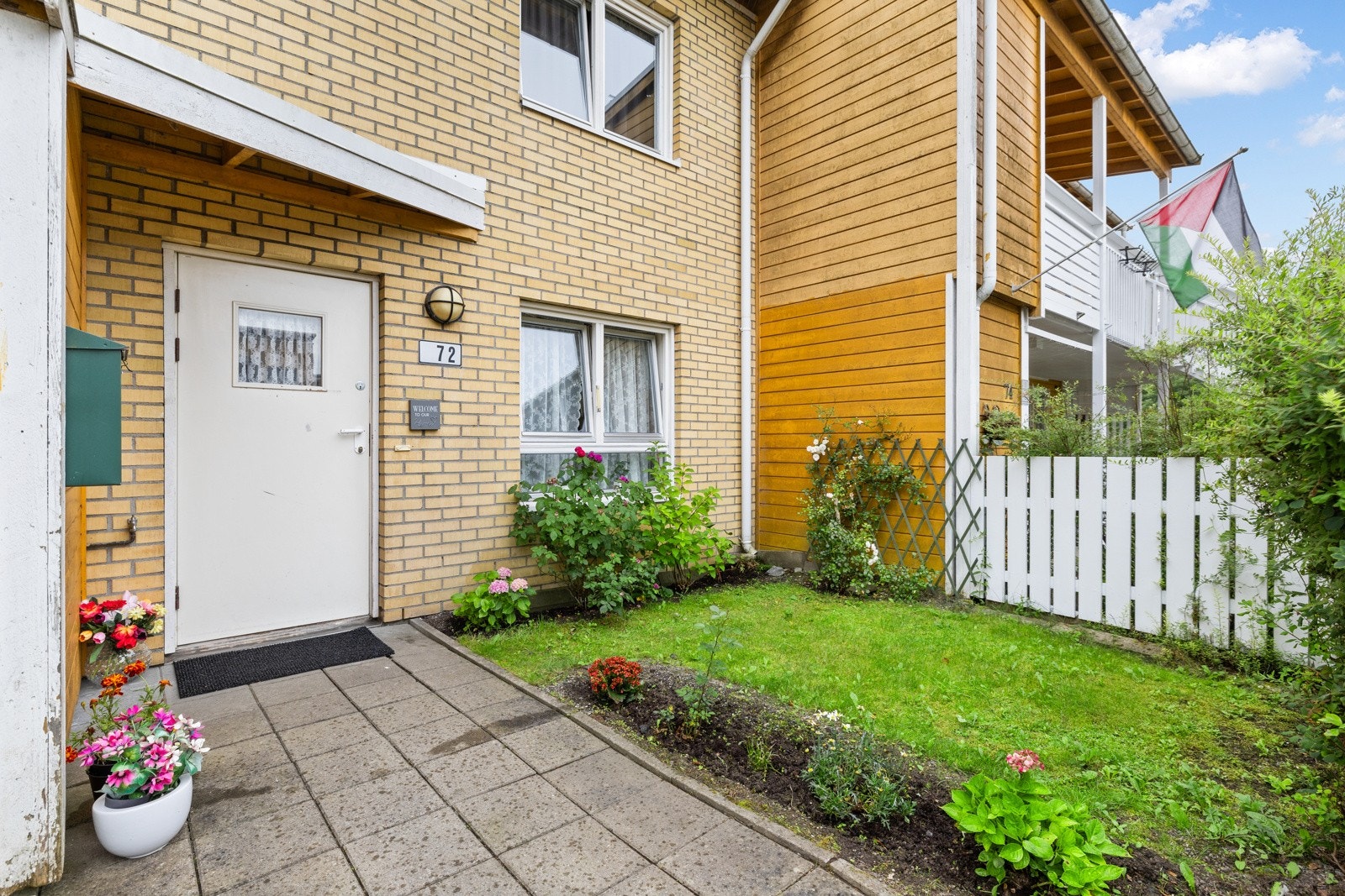 Hyggelig inngangsparti, med betongheller og hageflekk Galleribilde