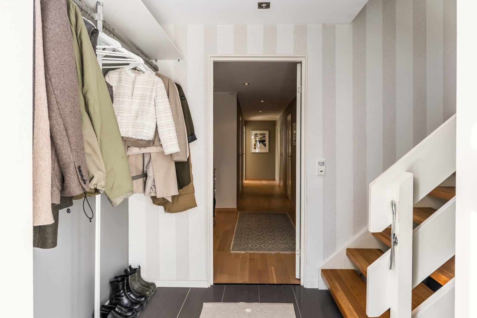 Man kommer inn i en flislagt entré (varmekabler) og videre inn i en romslig gang. Galleribilde