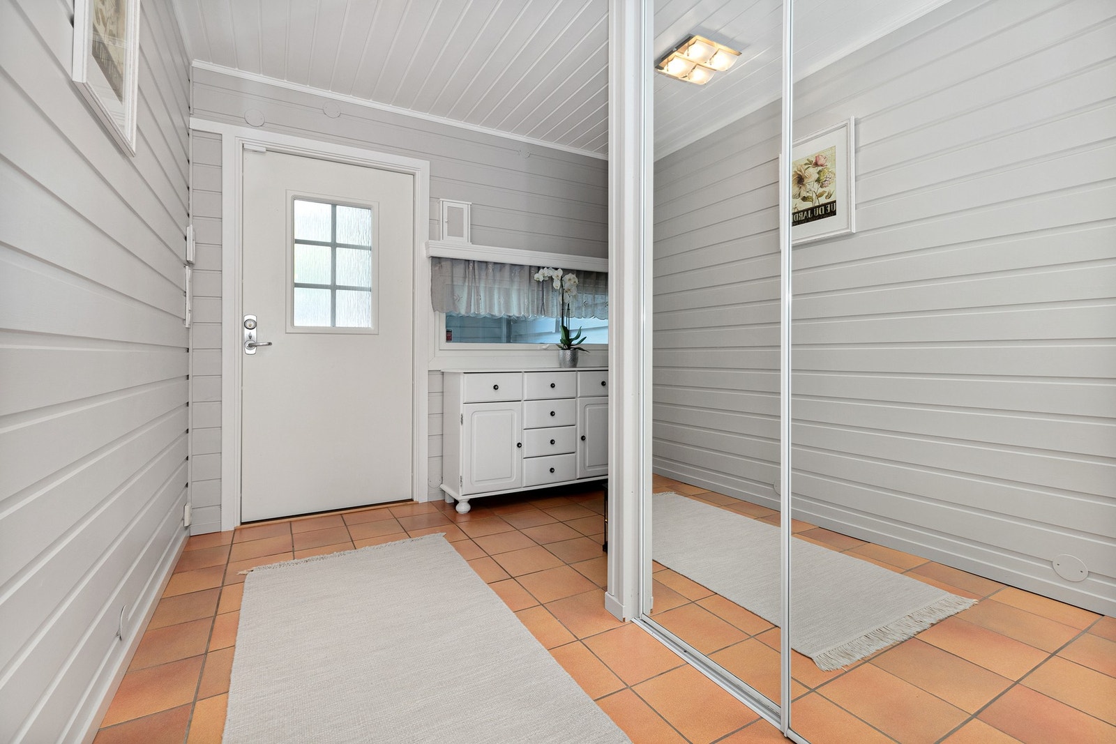 Flislagt gang/entrè med varmekabler og stor skyvedørsgarderobe. Galleribilde