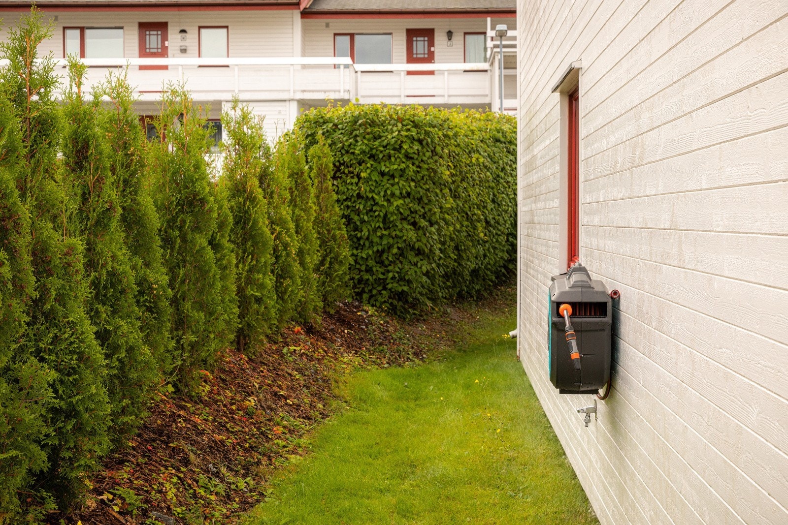 Gressplenen strekker seg rundt til markterrassen ved stuen Galleribilde