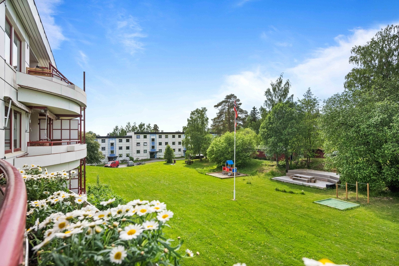 Borettslaget har store, flotte grøntområder med platting og lekeplass Galleribilde