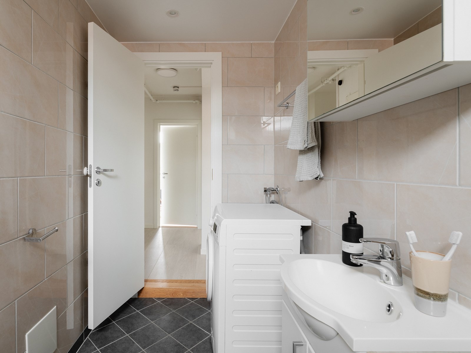 Det flislagte badet er arealeffektivt og utstyrt med varmekabler i gulv. Galleribilde