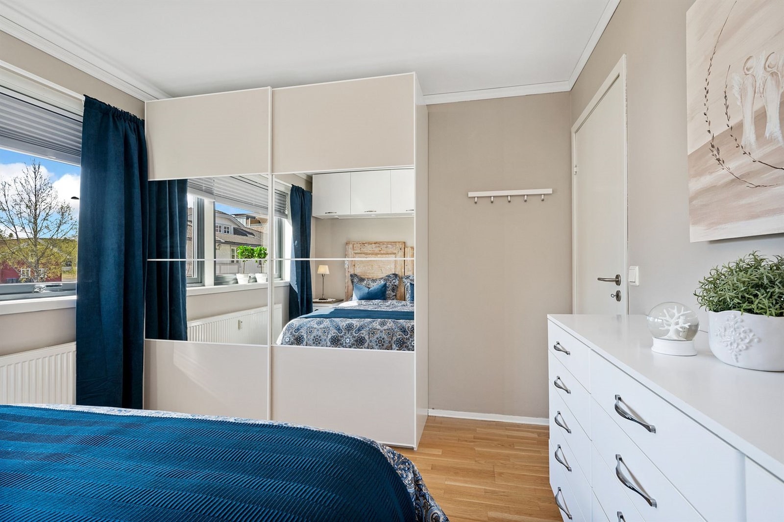 Stor garderobe med skyvedører. Det er montert lys inne i skapet Galleribilde