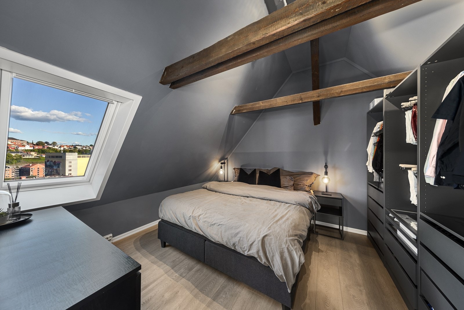 Hovedsoverom er malt i en mørk, behagelig farge på vegger og i himling. Rommet har en ny garderobeinnredning fra 2023 med glatte fronter på skuffer og god plass for heng i åpne hyller. Galleribilde