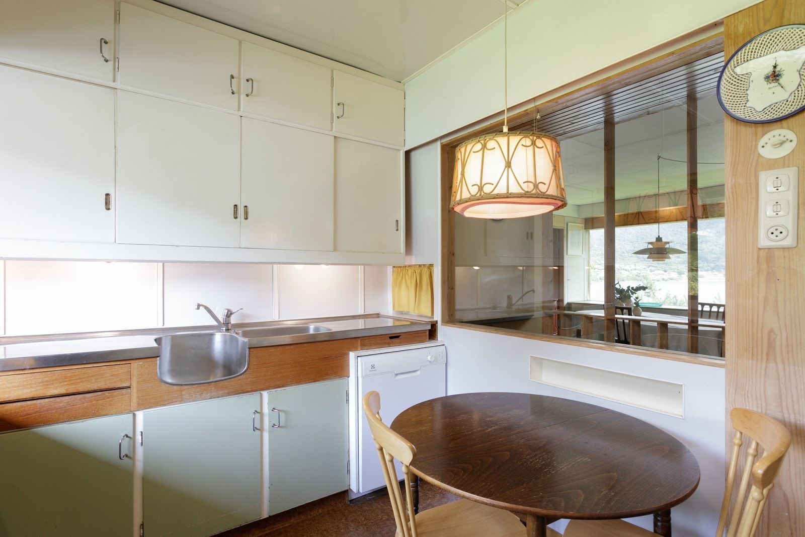 Arkitekt har lagt vekt på gjennomgående lys og utnyttet veggen til takhøy innredning på kjøkkenet Galleribilde