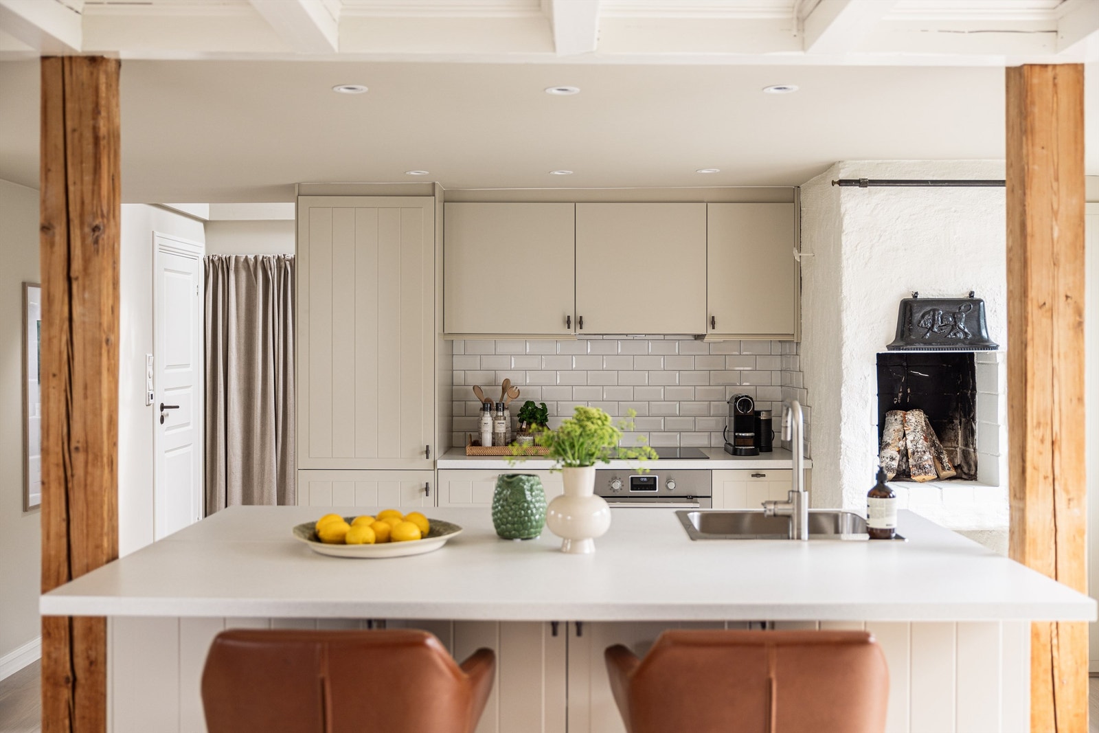 En vedfyrt peis i hjertet av kjøkkenet byr på en hyggelig atmosfære på kvelden. Galleribilde