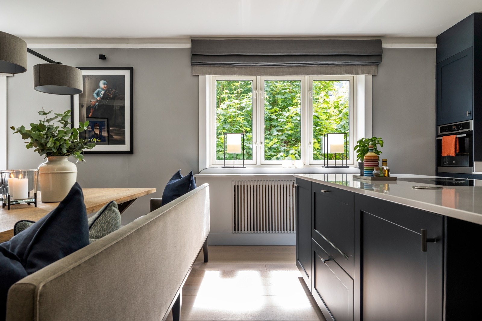 En kjøkkenøy setter et naturlig skille mellom kjøkkenet og stuen, og bidrar til ekstra lagrings- og benkeplass Galleribilde