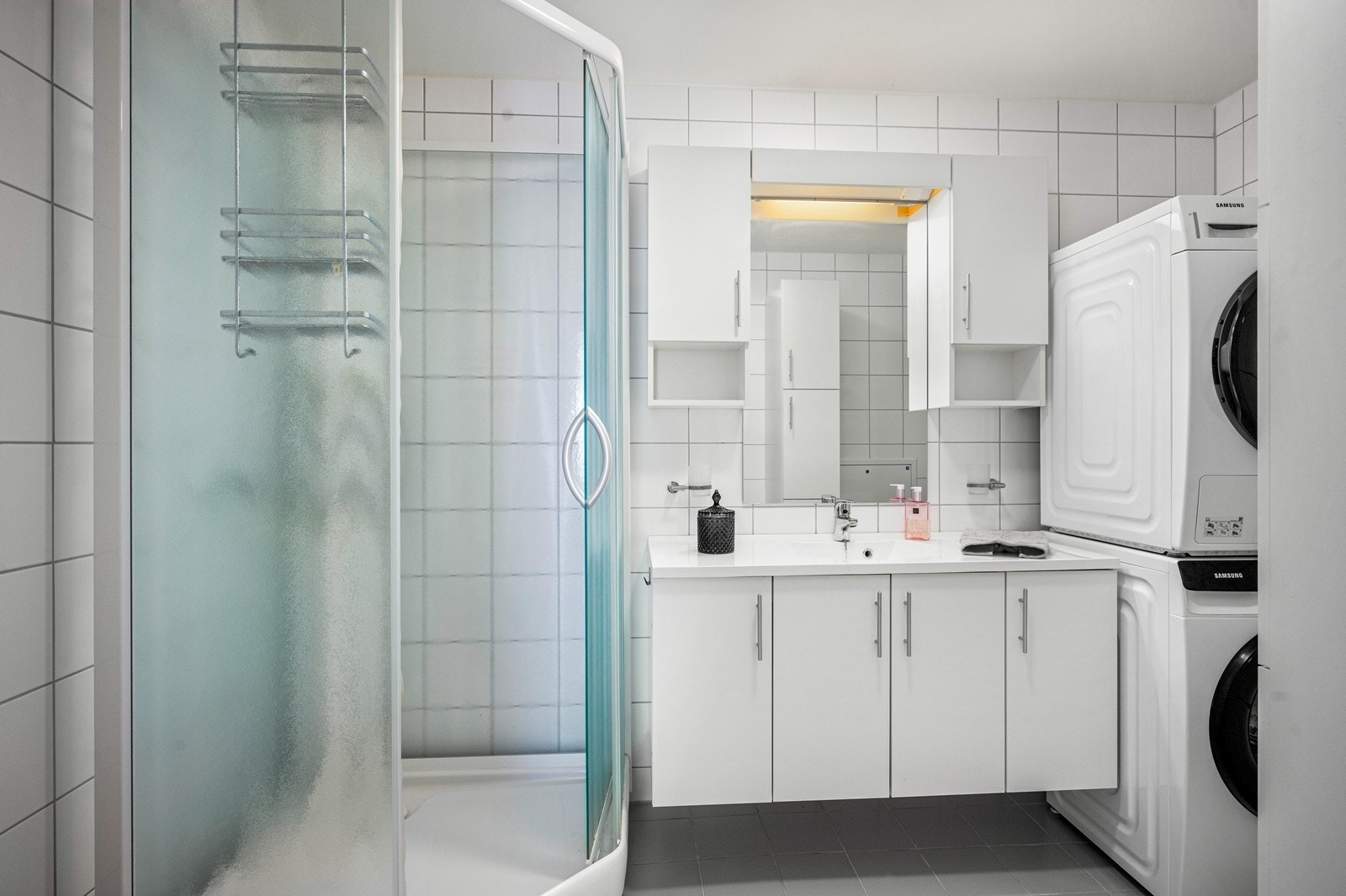 Badet har fliser på vegger og gulv og elektriske varmekabler Galleribilde