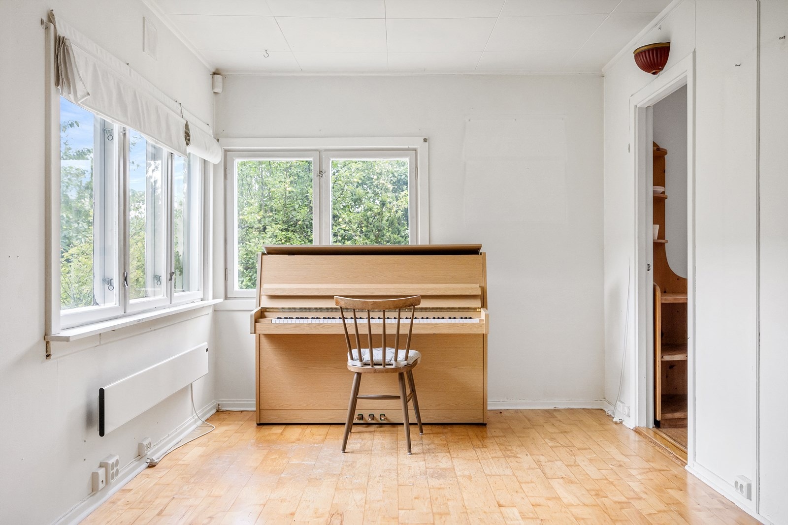 Stuen har store vinduer som slipper inn mye naturlig lys. Galleribilde