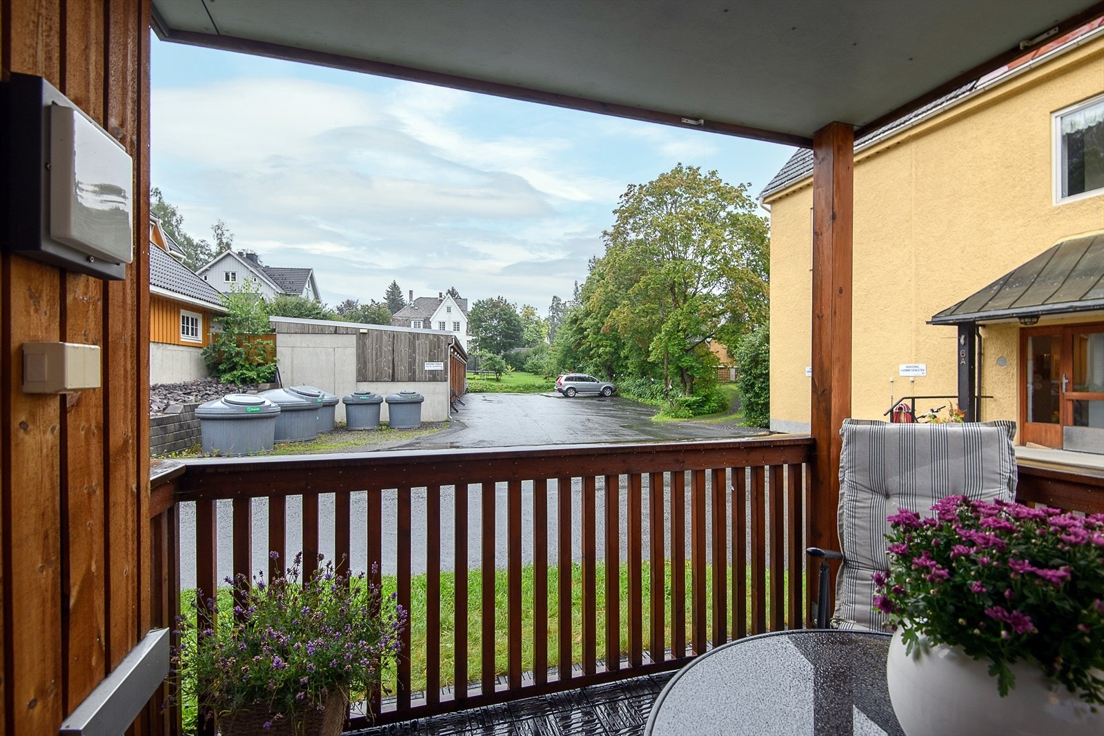 Fra terrasse mot felles garasjeanlegg hvor leiligheten disponerer en biloppstillingsplass. Galleribilde