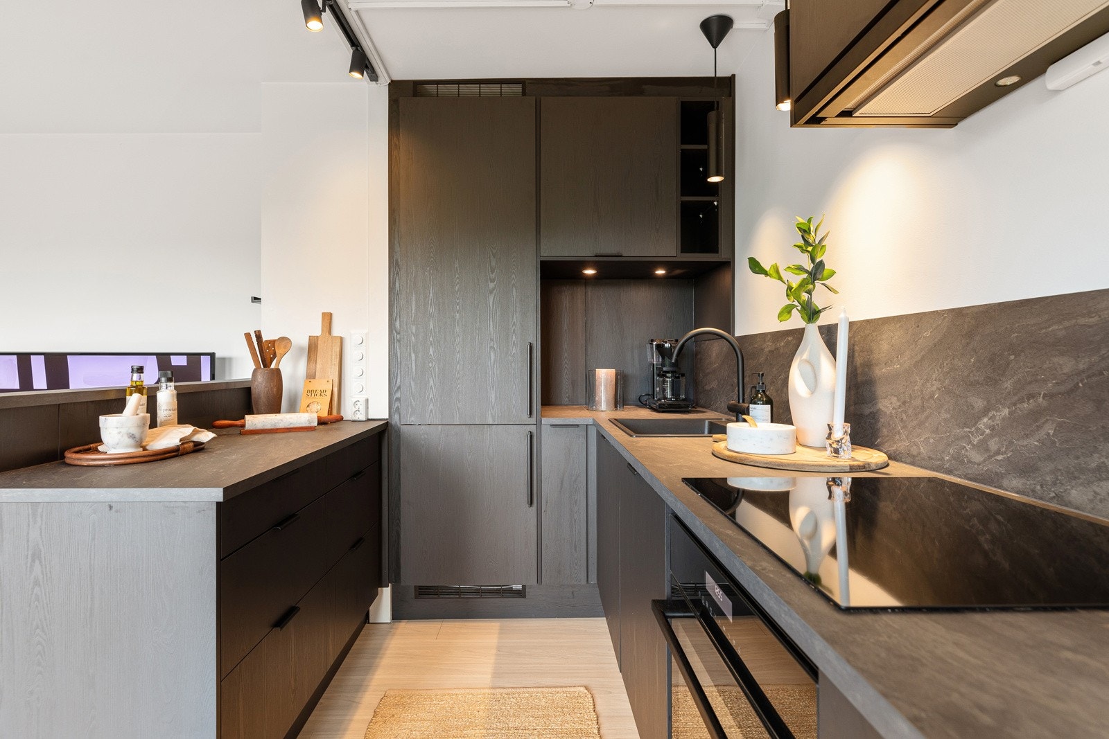 Grå laminat benkeplate med nedfelt sort komposittvask og ett-greps armatur i sort Galleribilde