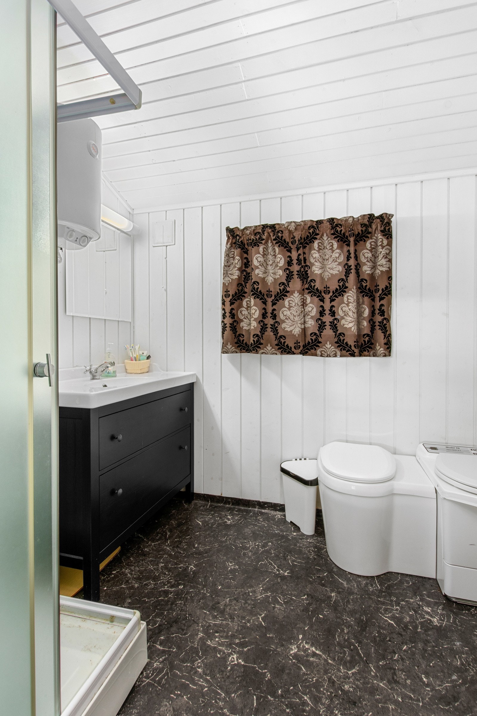 Bad med belegg på gulv og vegger. Malt himling i tak. Stråleovn på vegg Galleribilde