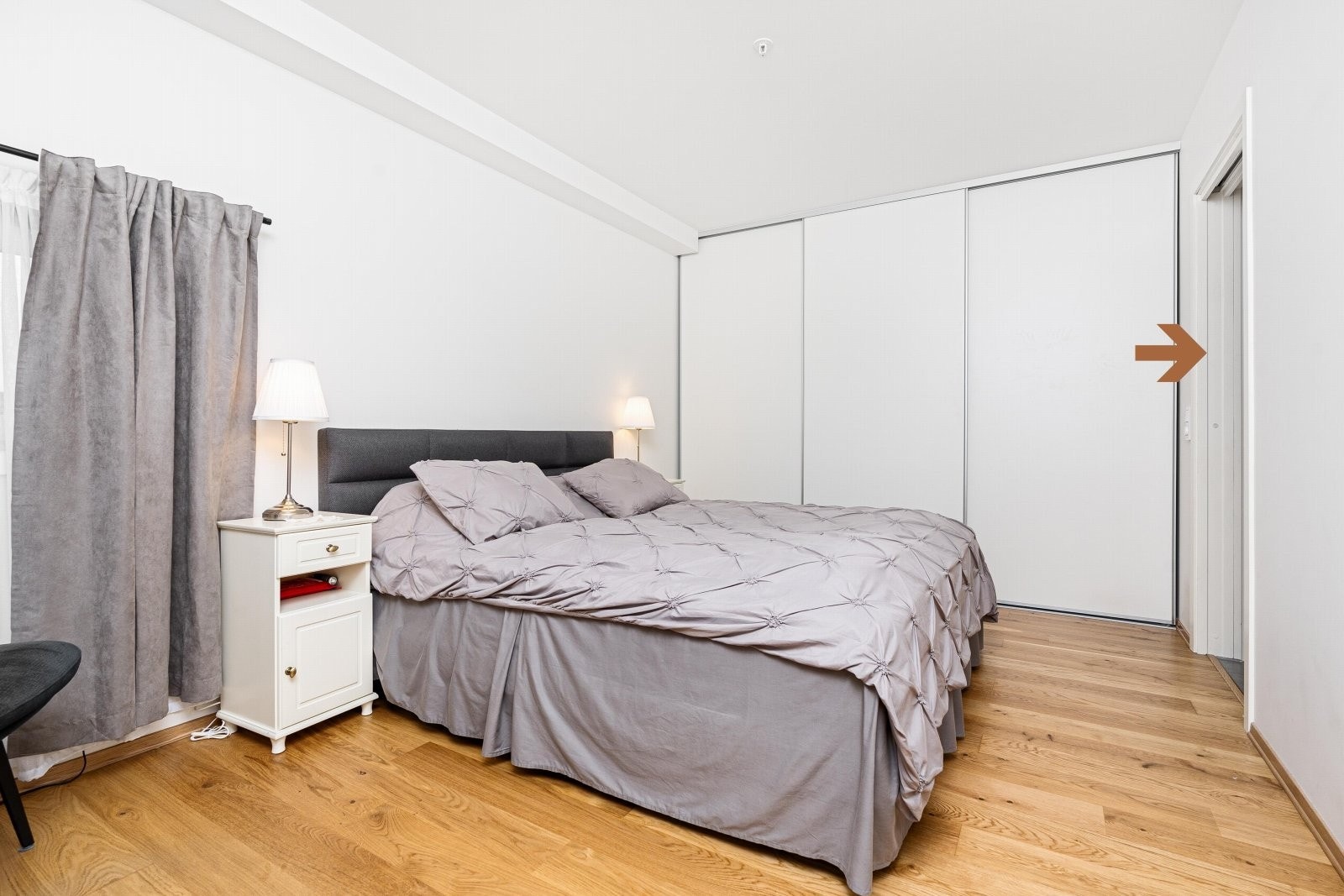 Hovedsoverom med skyvedørsgarderobe og inngang til eget bad Galleribilde
