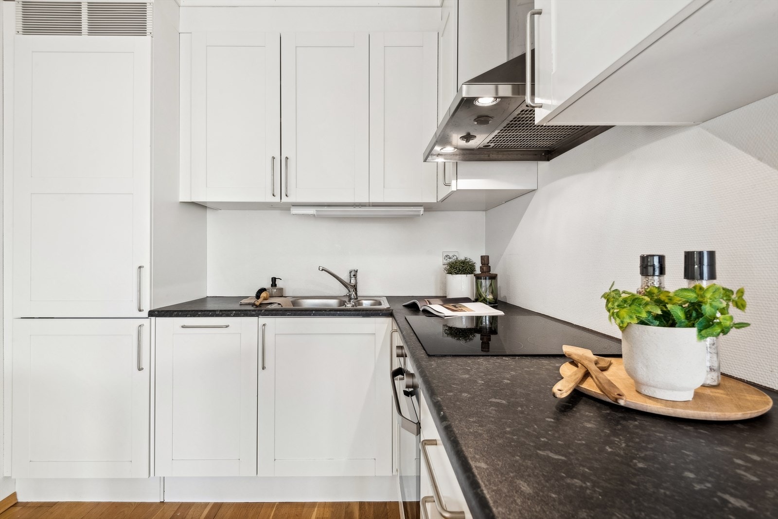 Lys og funksjonelt kjøkken med profilert innredning i L-formet løsning. Galleribilde