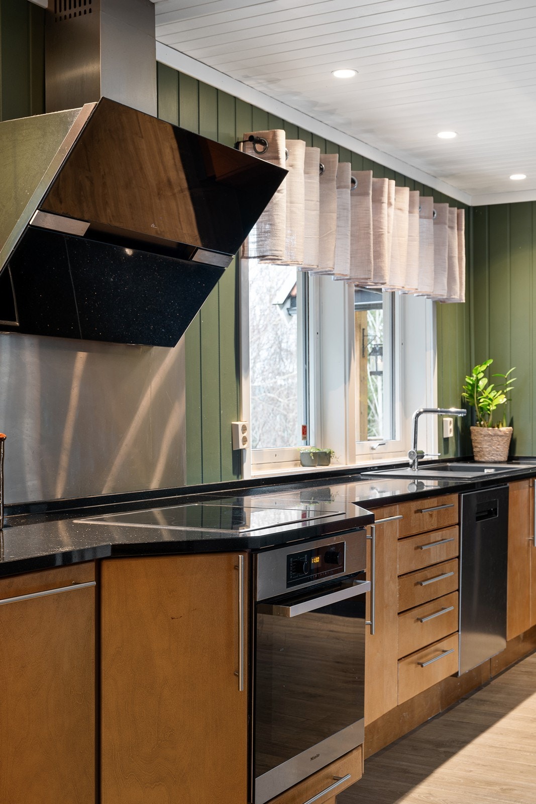 Videre er kjøkkenet utstyrt med integrerte hvitevarer som oppvaskmaskin, stekeovn og koketopp, samt ventilator, benkestikk og god arbeidsbelysning. Galleribilde