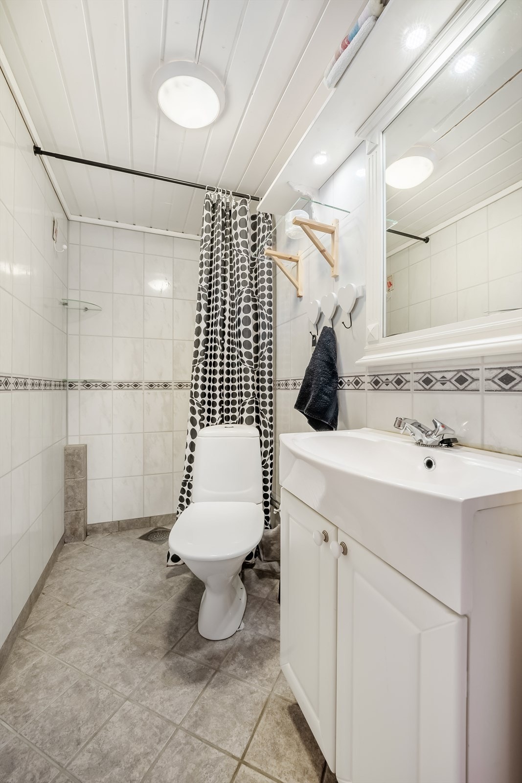 Bad med toalett, servantskap med speil og dusj Galleribilde