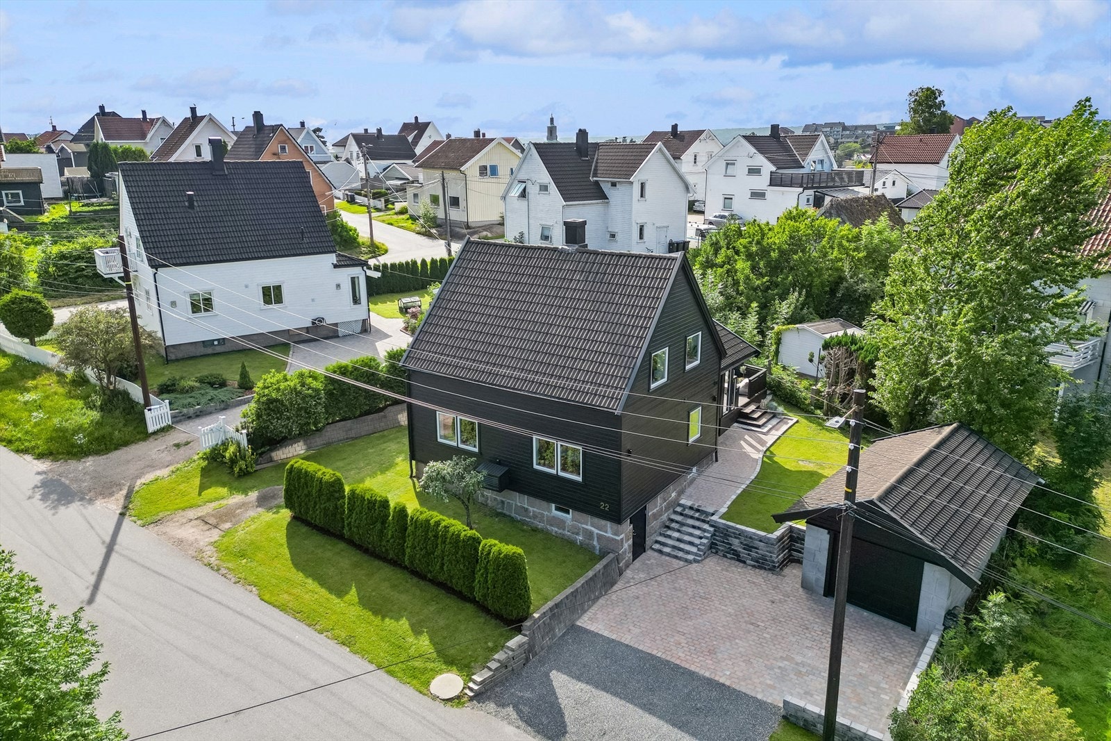 Eiendommen er pent opparbeidet med hekk, gressplen, forstøtningsmurer, naturstein og steinlagt/ gruset gårdsplass. Galleribilde