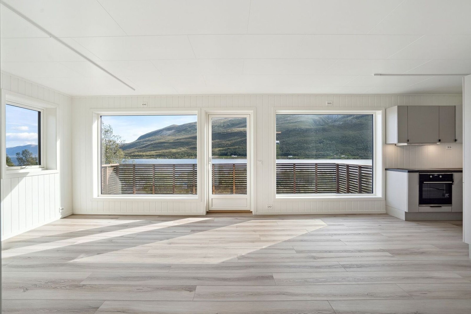 Fra gangen så kommer du inn i en lys og trivelig stue med store vinduer i front (bilder er fra tilsvarende speilvendt leilighet i 2 etg.). Galleribilde