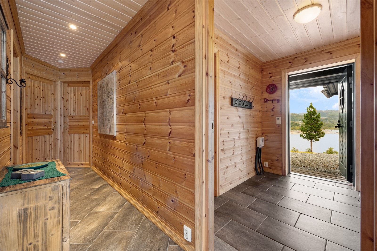 Fliselagt gulv i entré og god plass for oppbevaring av yttertøy. Her er det også inngang til vaskerommet. Galleribilde