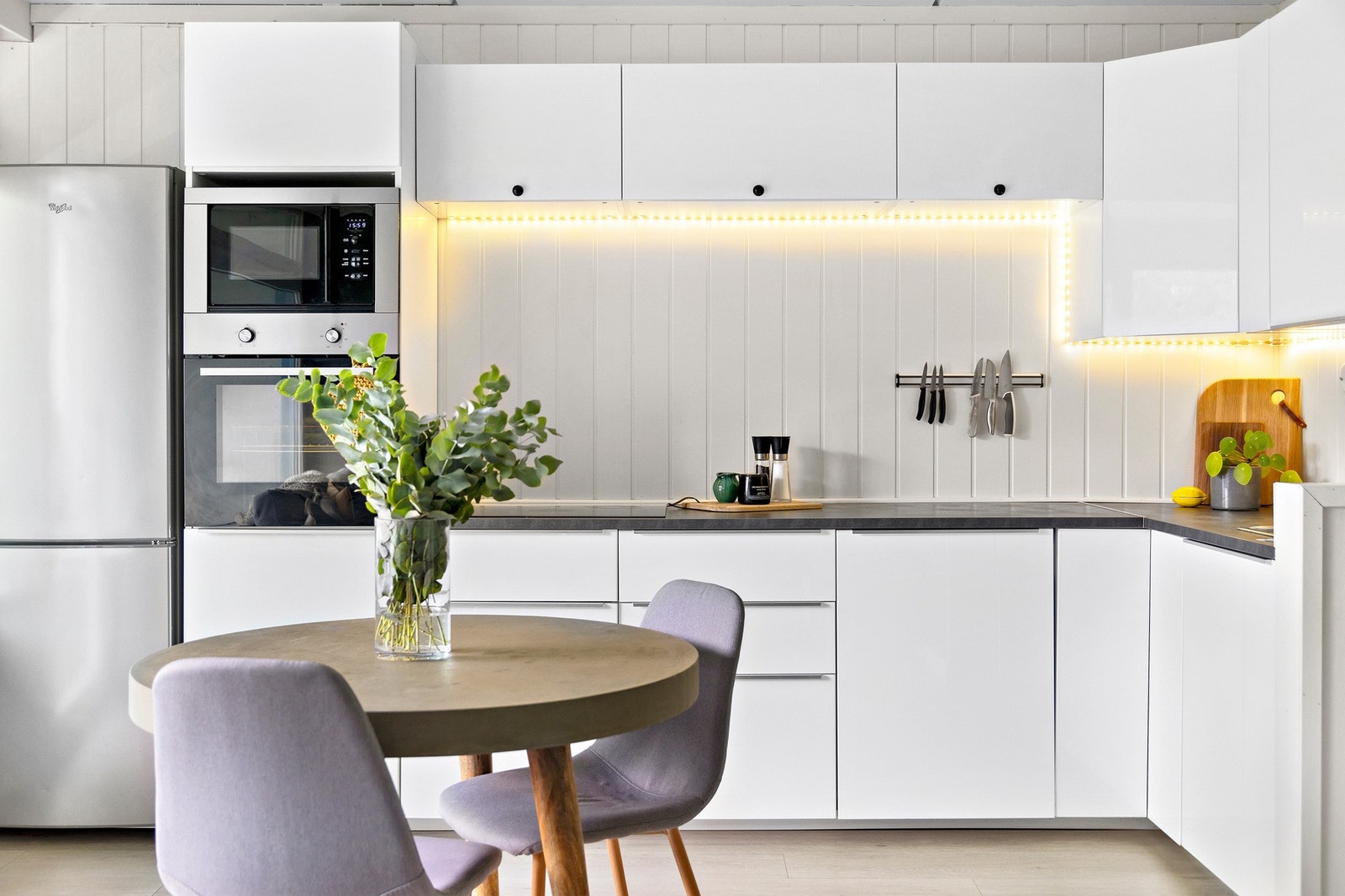 IKEA-kjøkkenhjørne fra 2014 med lyse, glatte fronter, laminat benkeplate og nedfelt kum. Galleribilde