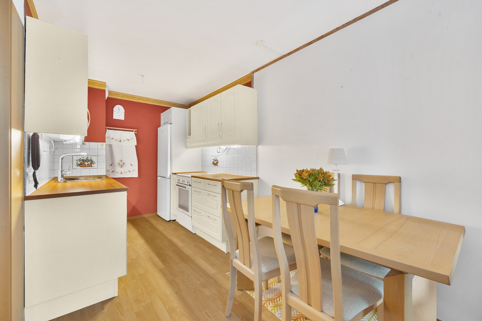 Sjarmerende kjøkken fra Drømmekjøkkenet med lyse profilerte fronter og laminat benkeplate med vask Galleribilde