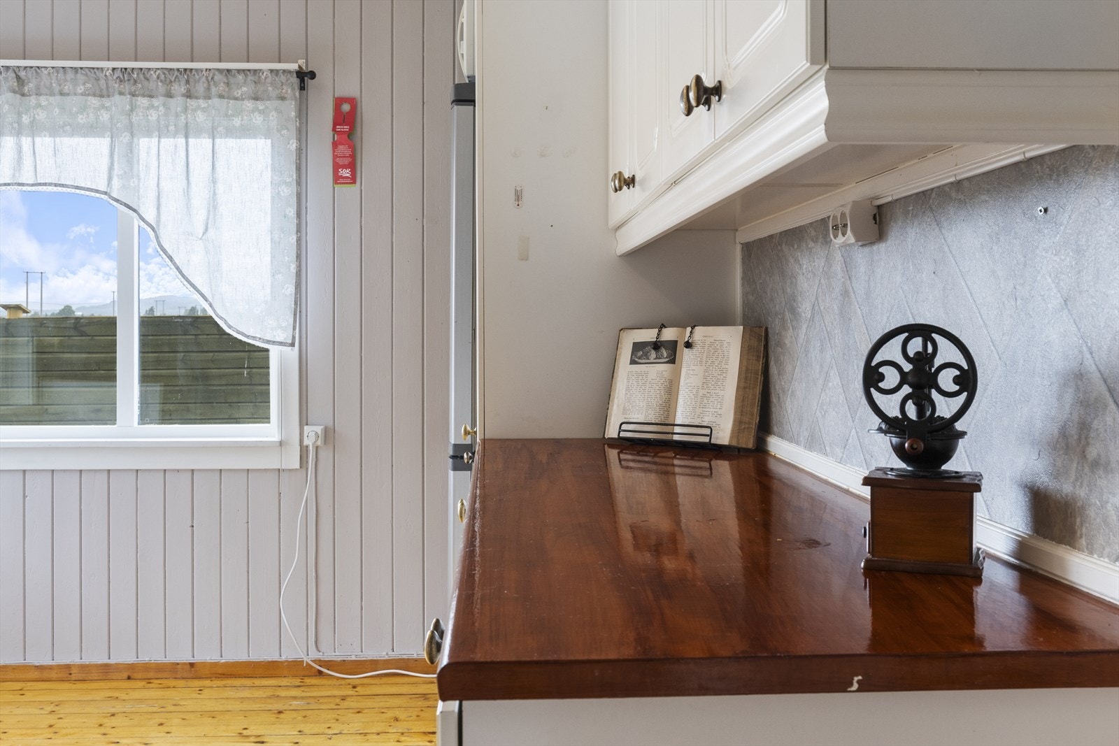 Kjøkkenet har laminerte plater i benkerygg, malt panel på vegg og i himling. Behandlet tre på gulv. Galleribilde