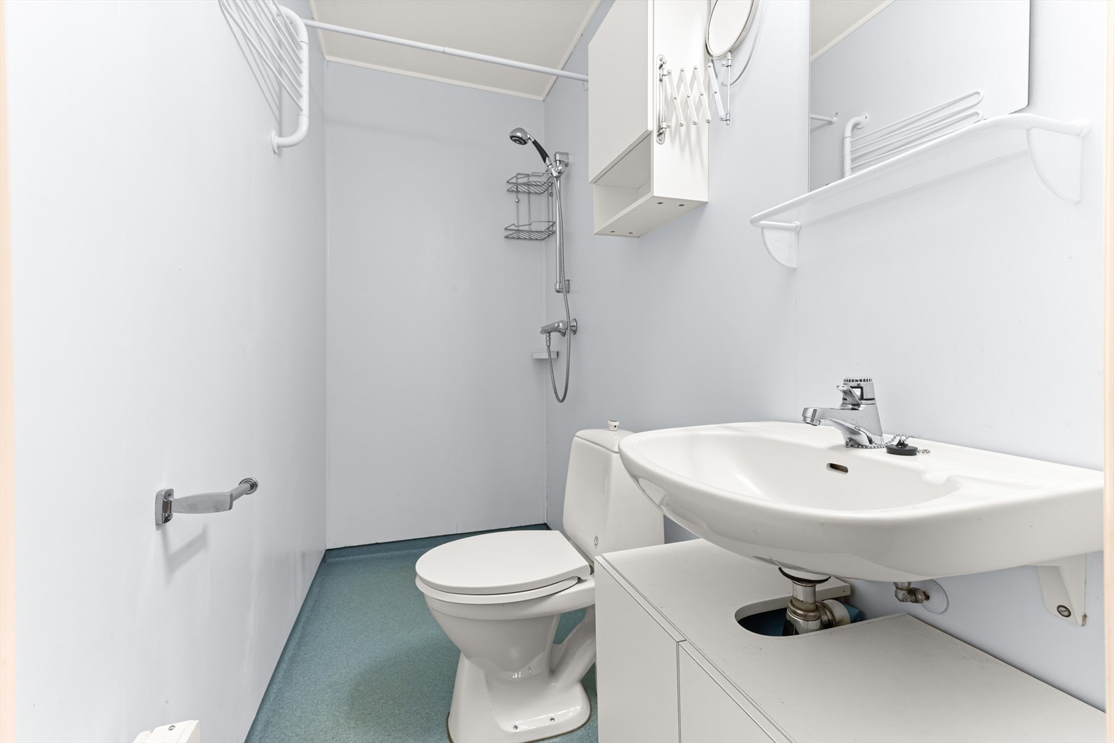 Badet er av eldre standard med våtromsplater på veggene og våtromsbelegg på gulvet. Galleribilde