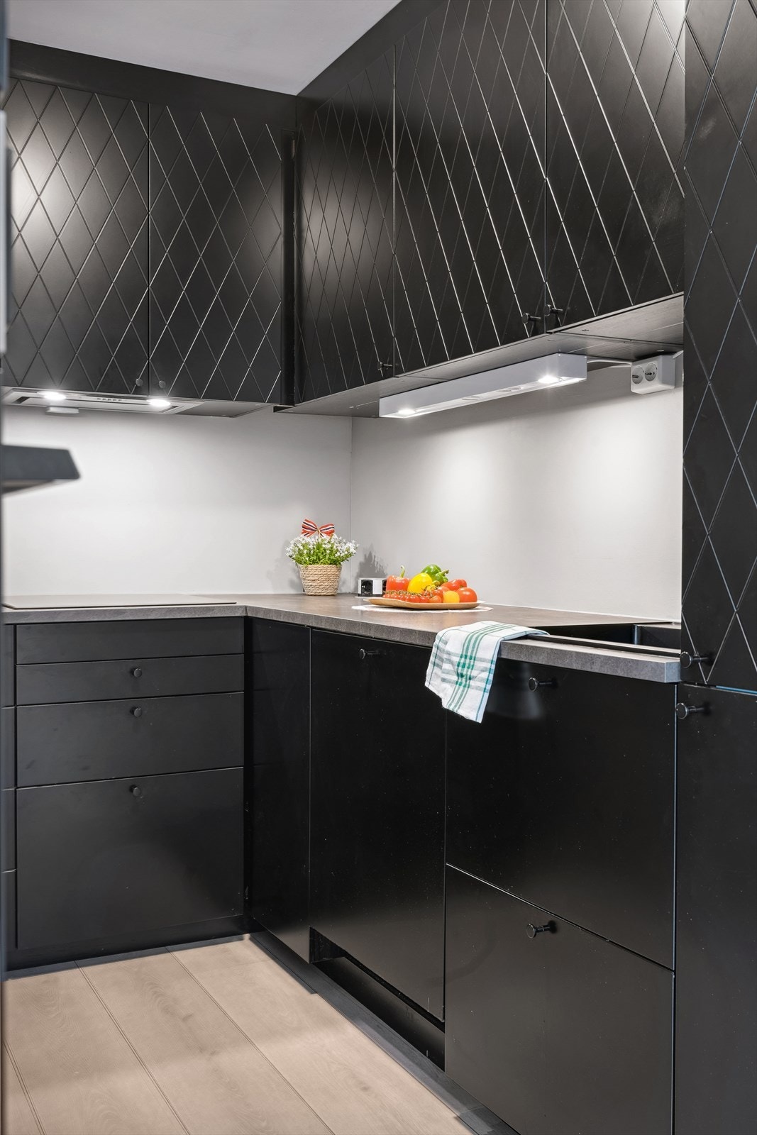 Innredning med glatte, fabrikklakkerte fronter. Laminat benkeplate med nedfelt kum i kompositt/plast. Galleribilde