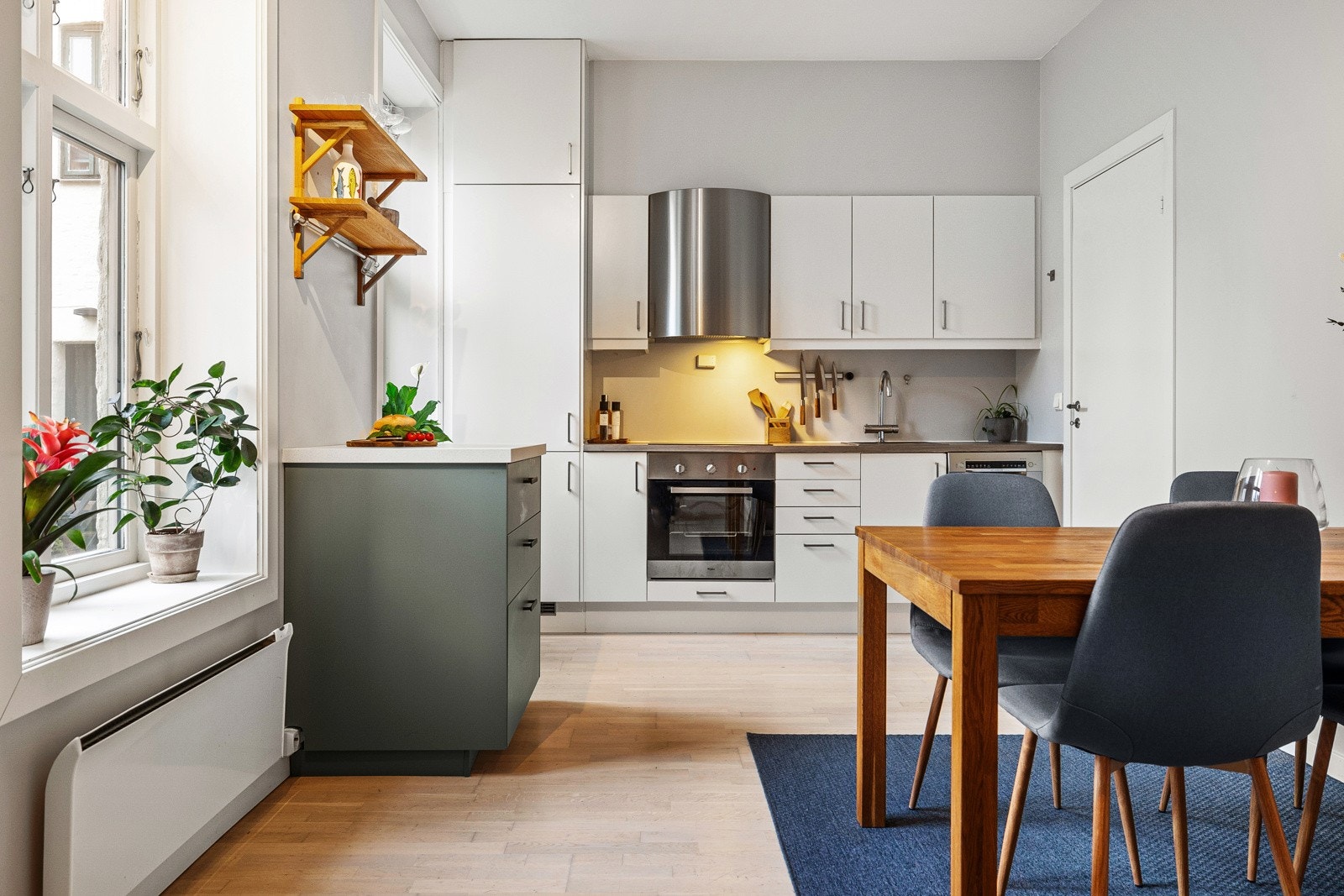 Moderne og åpent Sigdal kjøkken fra 2014 med slette fronter og laminert benkeplate med nedfelt stålkum. Galleribilde