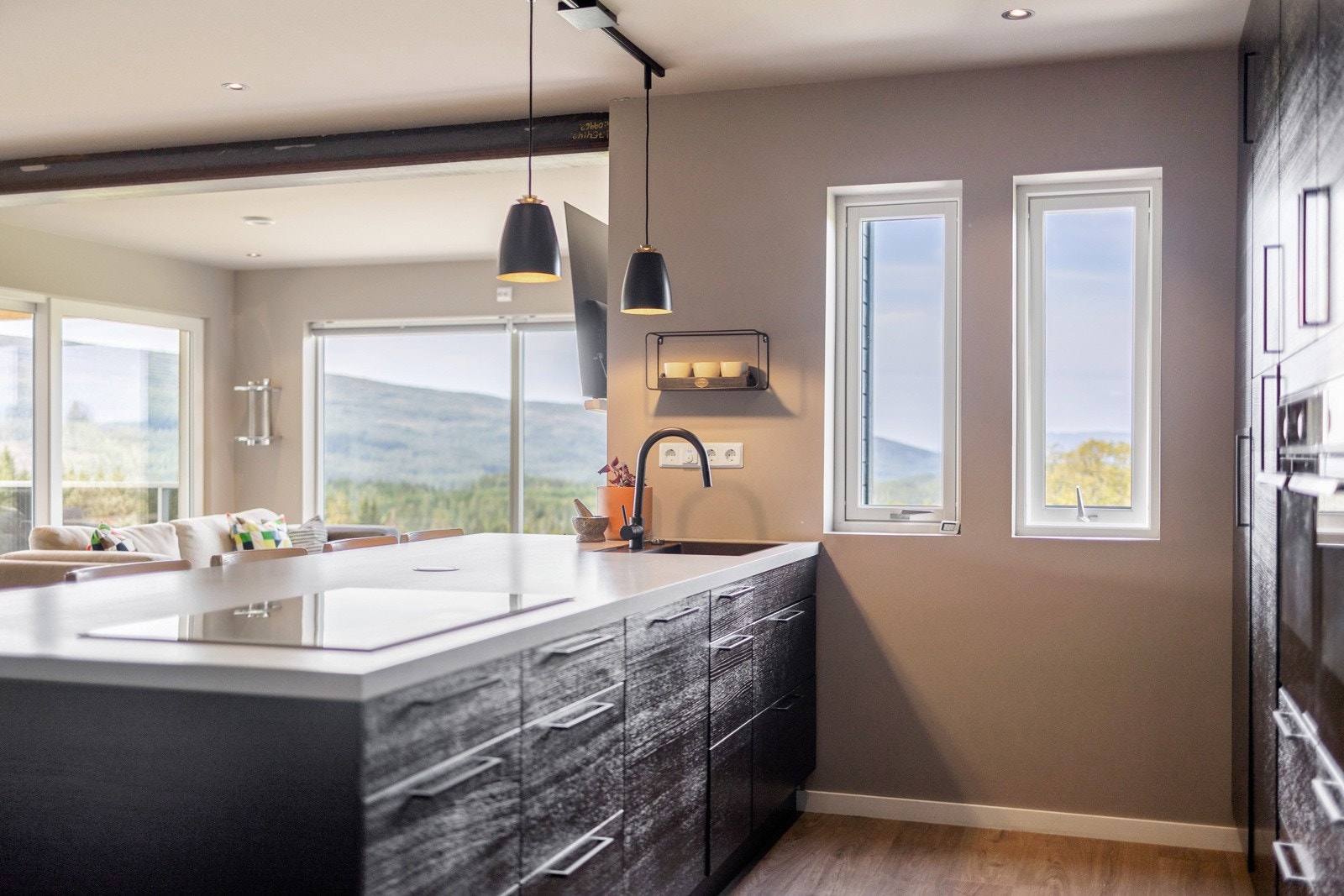 Kjøkken med integrerte hvitevarer som helt kjøleskap, fryseskap, to stekovner, platetopp, oppvaskamskin og takventilator. Galleribilde