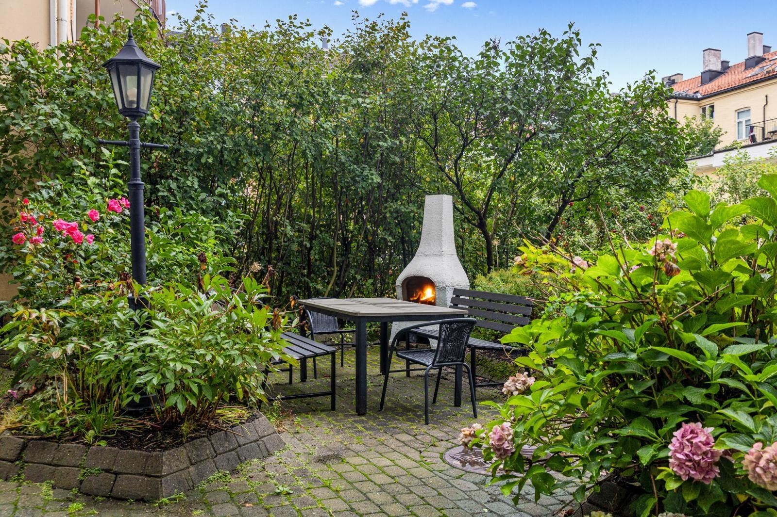 Sameiets bakgård er pent opparbeidet med sittegruppe, utepeis og diverse beplantning. Galleribilde