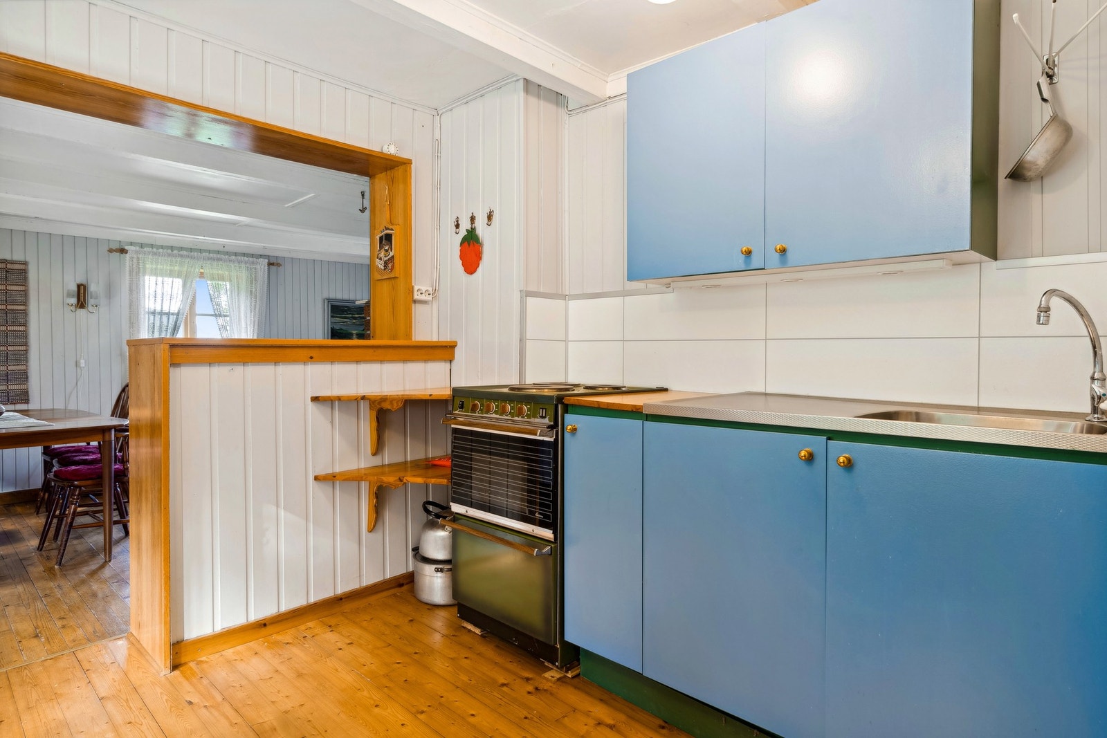 Eldre kjøkkeninnredning av tre med malte fronter og lakket benkeplate Galleribilde