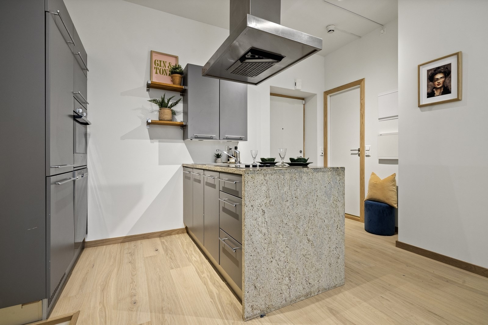 Stilren kjøkkeninnredning med grå glatte fronter. Galleribilde