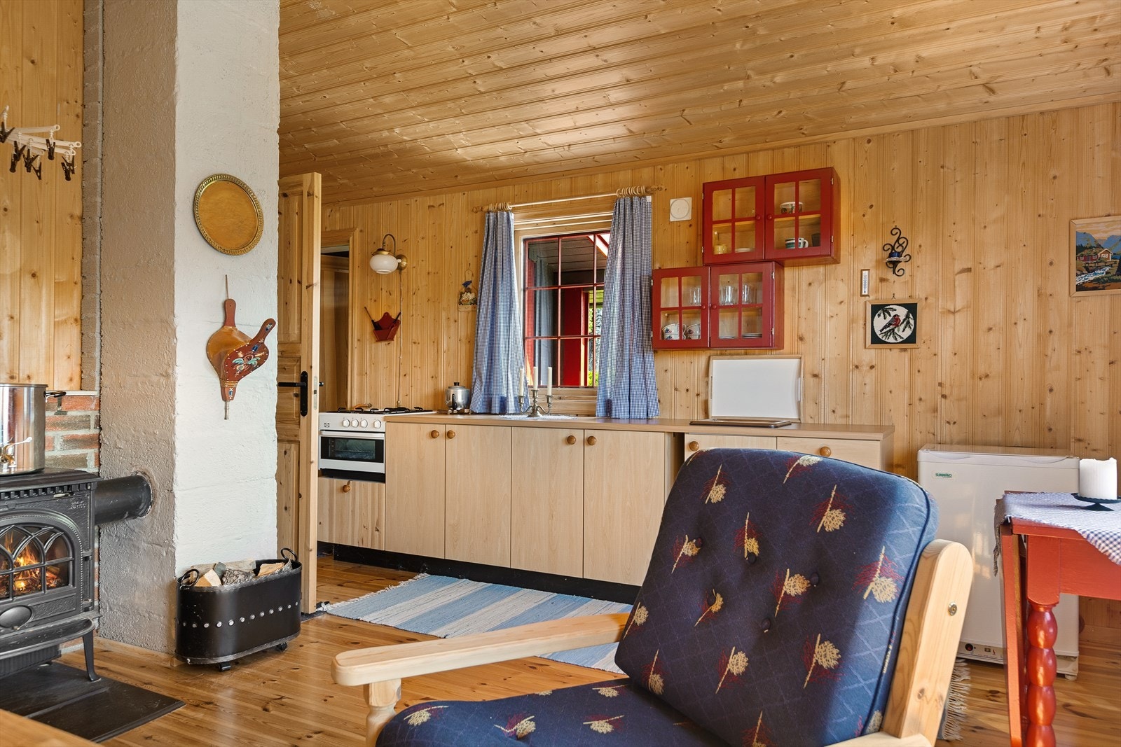 Stue og kjøkken i åpen løsning. Kjøkkenet har godt med benkeplass, og har en liten gassovn, samt gasskjøleskap. Galleribilde