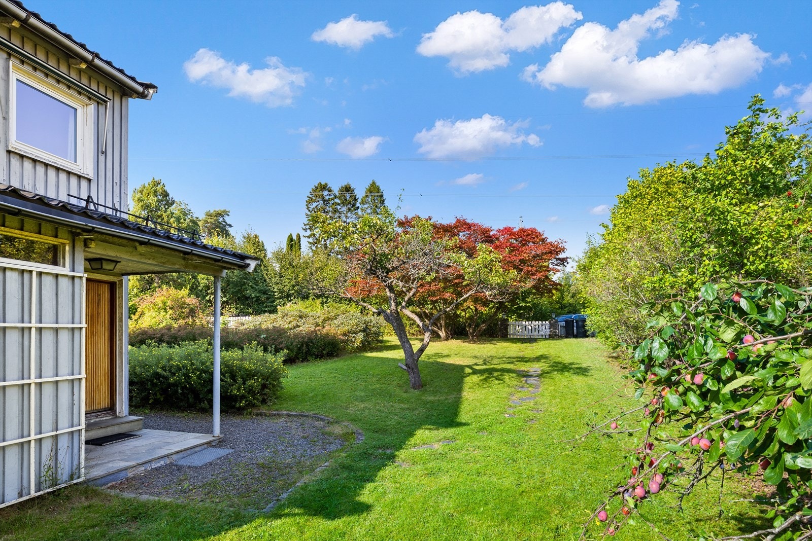 Her er det busker og trær og en hyggelig hagegang Galleribilde