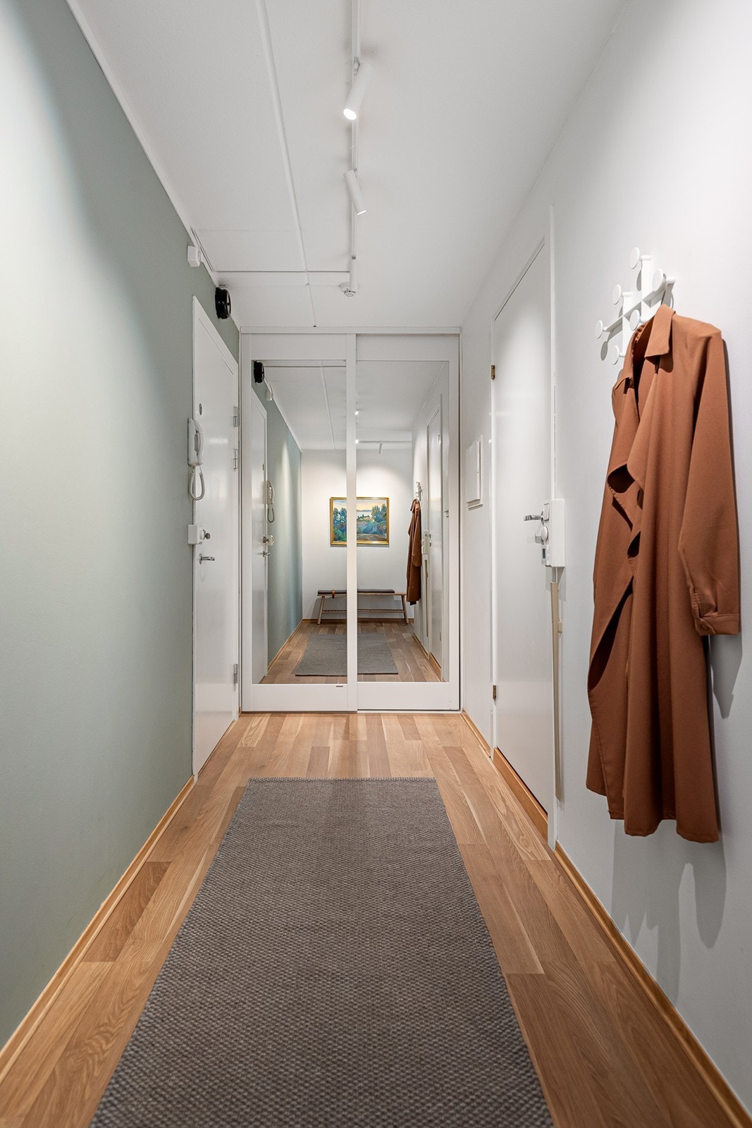 Innbydende og romslig gang med plassbygd garderobeskap Galleribilde