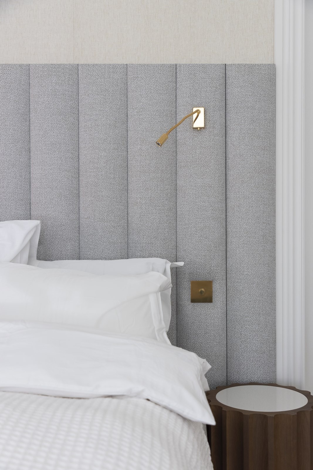 Sengegavlen er kledd med tekstil og utstyrt med integrerte lamper og brytere. Galleribilde