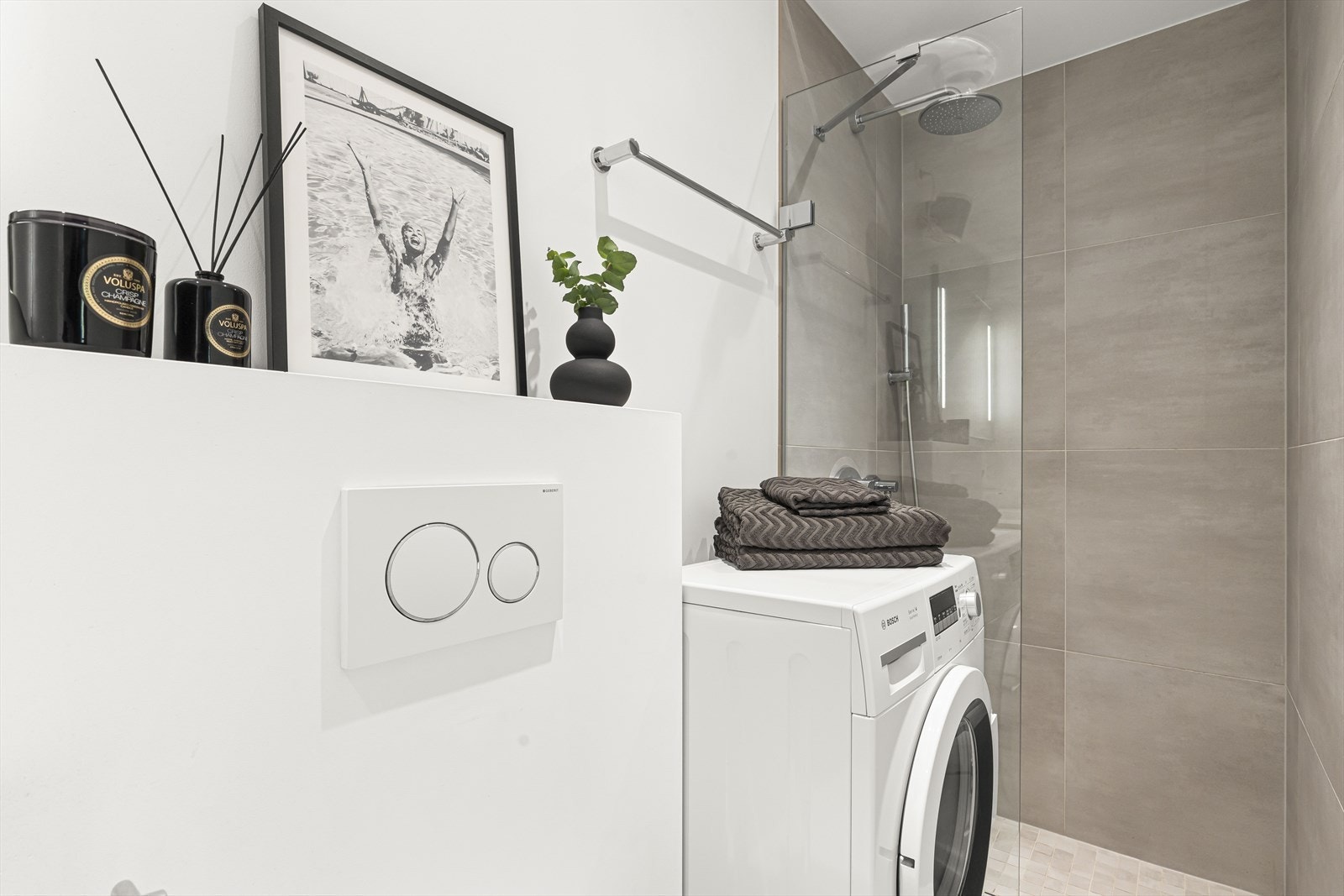 Delikat og moderne bad fra 2018, bestående av flislagt gulv med varmekabler, delvis flislagte og malte vegger samt lysmalt himling. Galleribilde