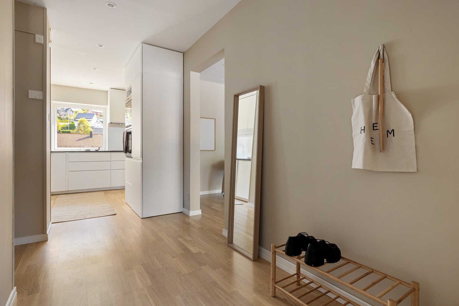 Leiligheten har en luftig entré med en åpen løsning inn om kjøkken Galleribilde