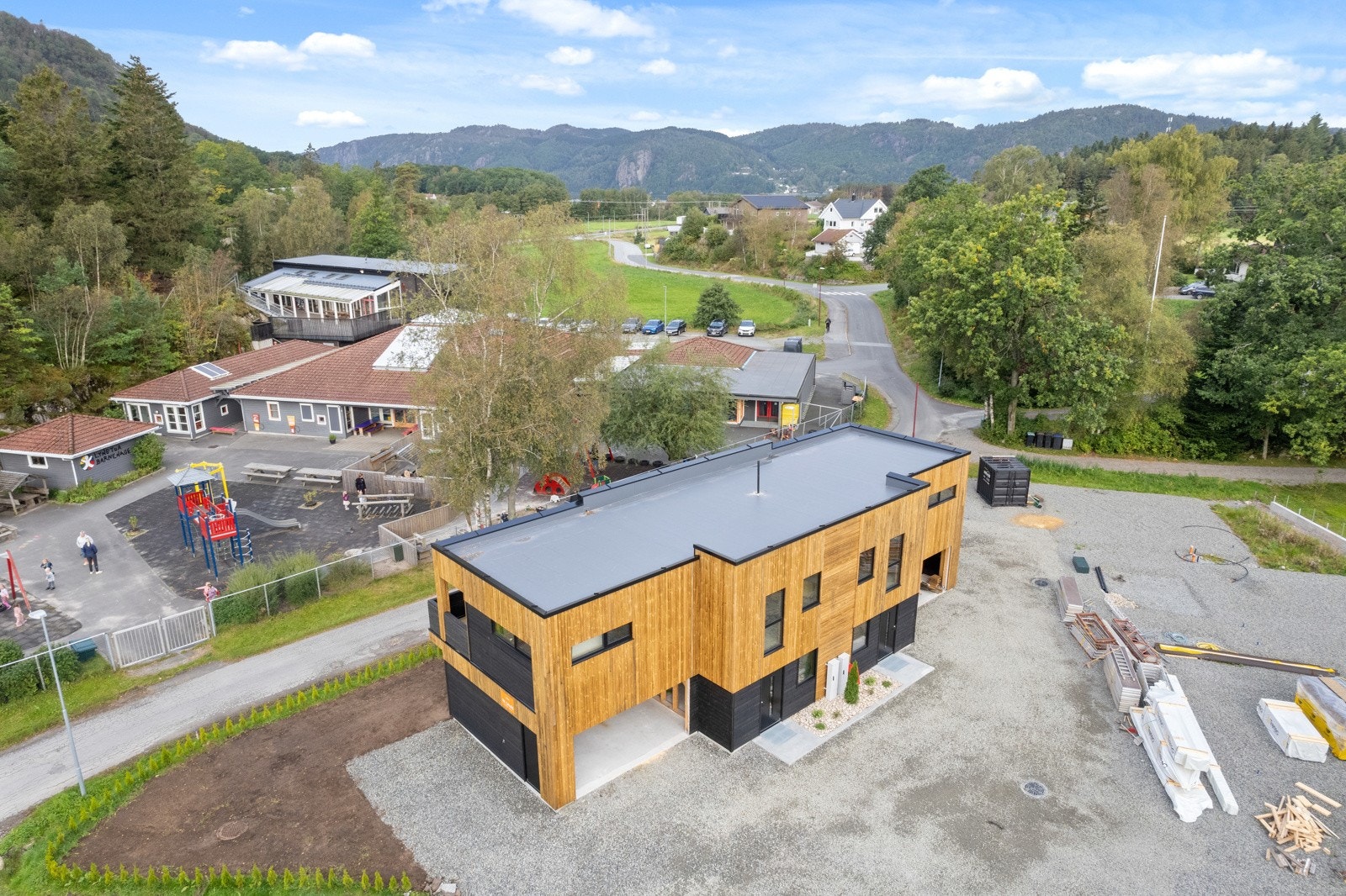 Barnehage med stor lekeplass like over veien. Galleribilde