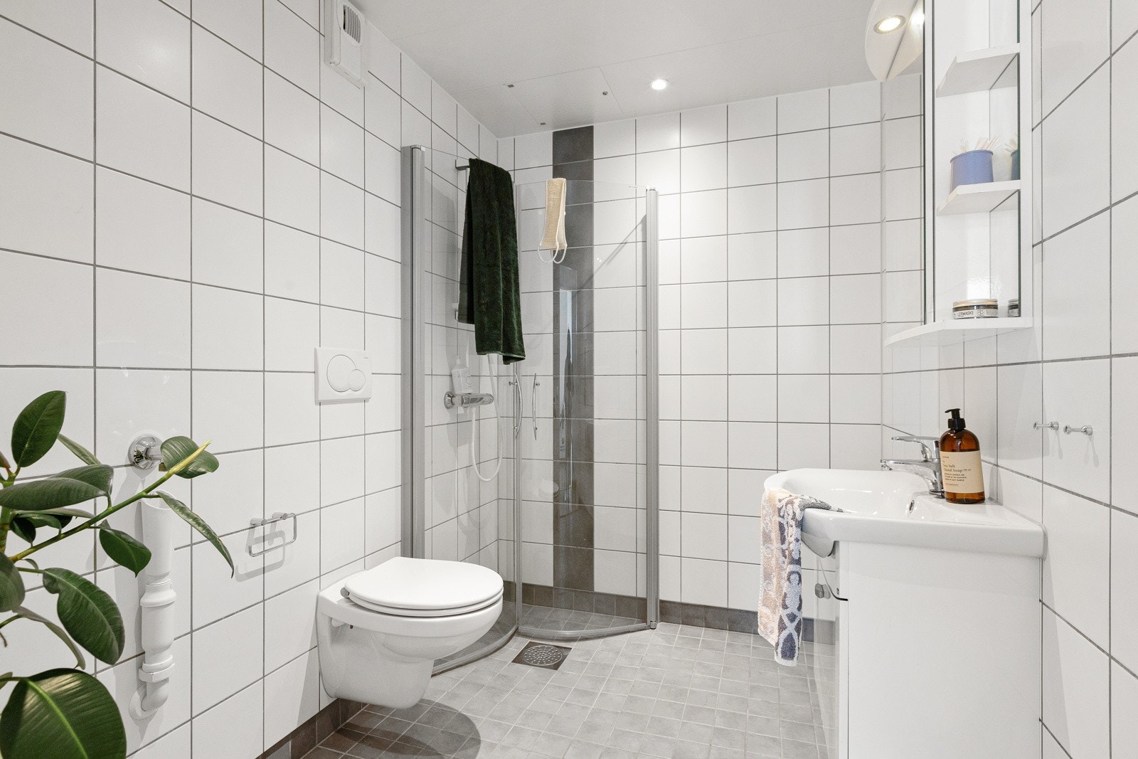Tidløst og flislagt bad fra byggeåret med gulvvarme og downlights i himlingen. Det er også opplegg for vaskemaskin. Galleribilde