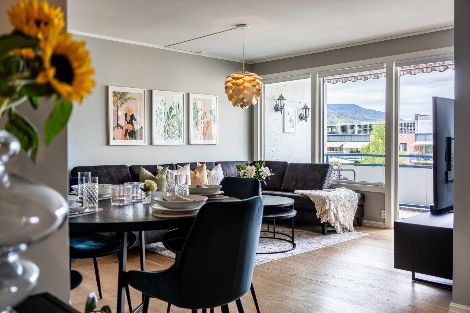 Dagslyset strømmer inn via store vinduer, og fra stuesonen er det utgang til en overbygd balkong. Galleribilde