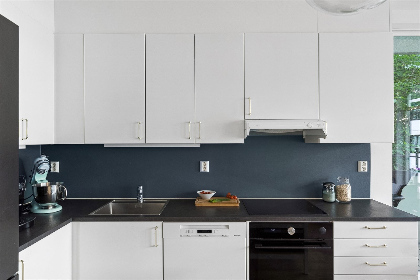 Kjøkkeninnredning med glatte fronter og integrerte hvitevarer. Galleribilde