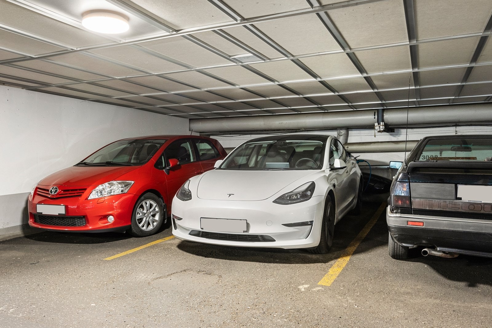 Egen garasjeplass i kjeller med elbillader (montert i 2019). Det er også godt med gjesteparkering i garasjeanlegget. Midterste plass. Galleribilde