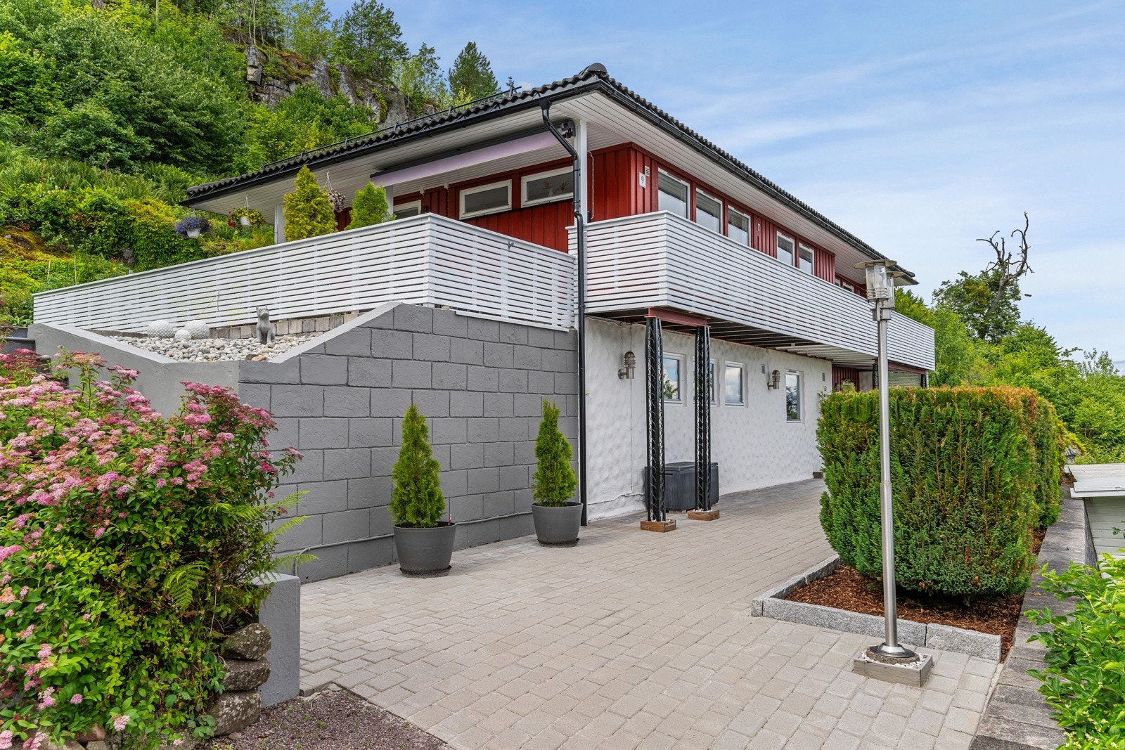 Belegningsstein med kantstein er lagt på hele fronten av huset og på verandaen i 2021. Galleribilde