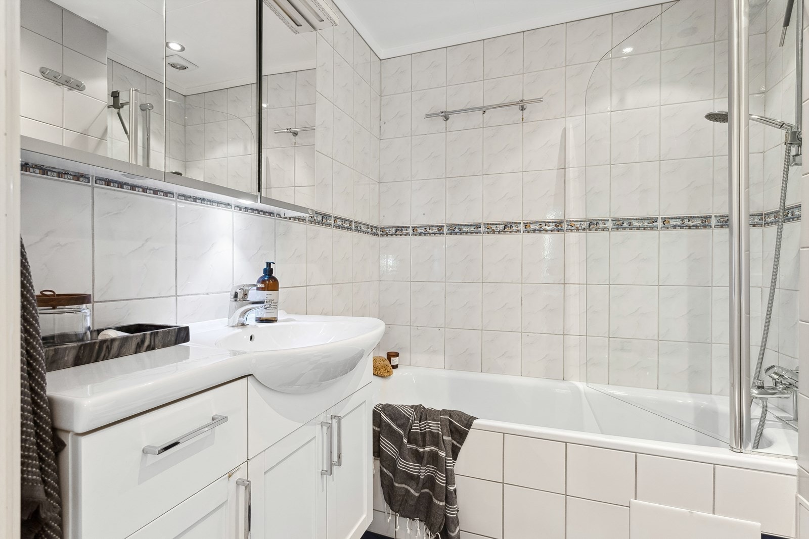 Baderommet har vegger og gulv med flislagte overflater og malte takplater med innfelte downlights(2 av disse fungerer ikke) Galleribilde